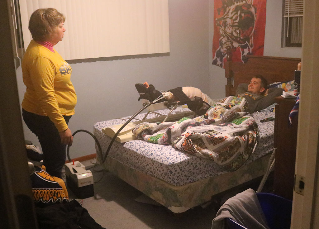 Laura Rachatellelle talks to her son Cody after the final home football game